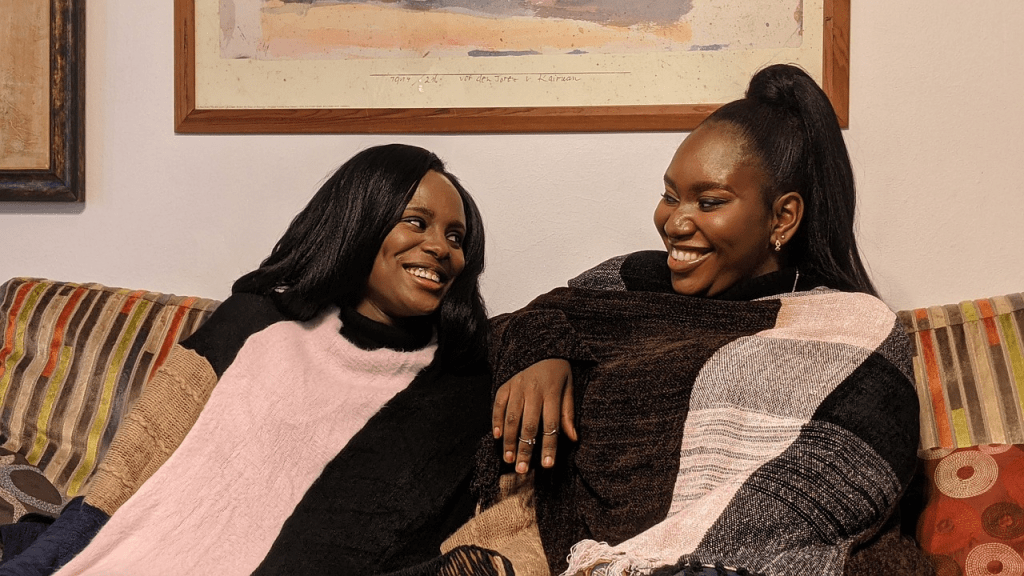 women on a couch chatting and smiling